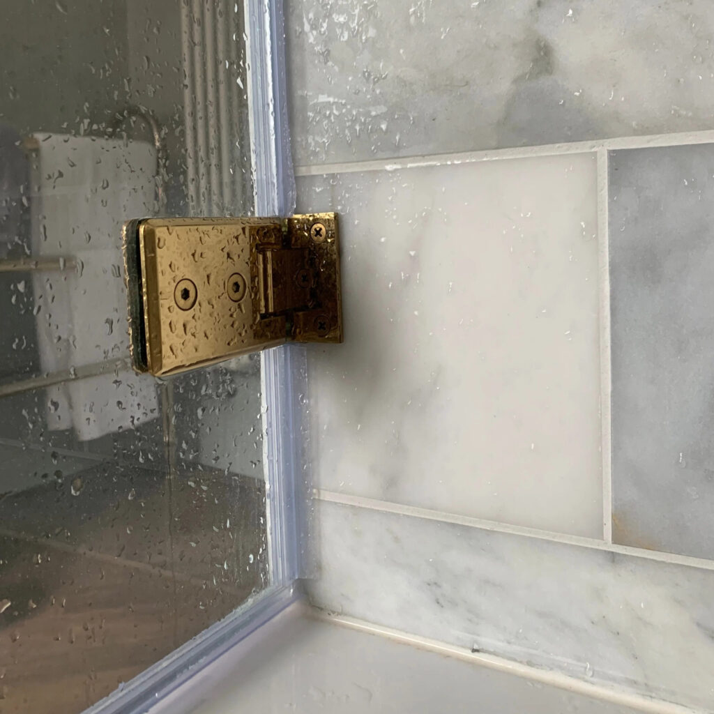 Bath Screen Brass Hinge Closeup