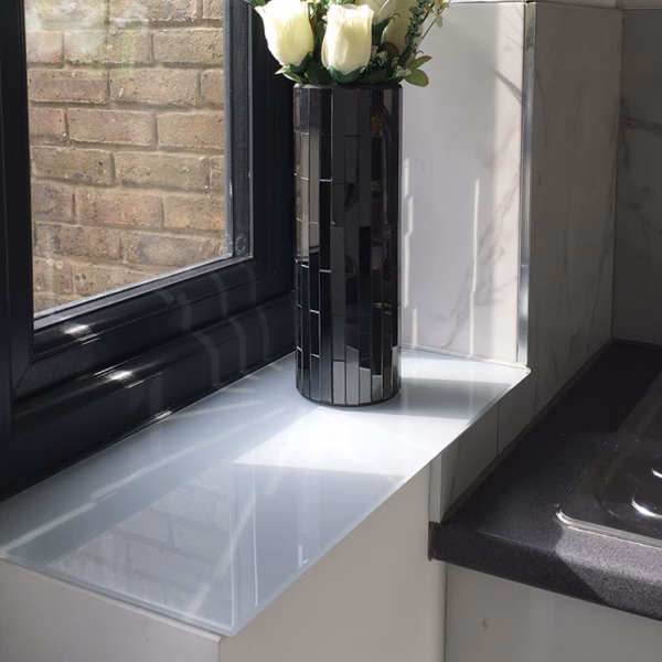 Light grey painted glass window sill in a kitchen