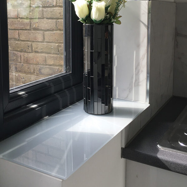 Light grey painted glass window sill in a kitchen