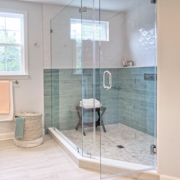 Toughened glass shower door attached to a wall with chrome glass toe wall hinges.